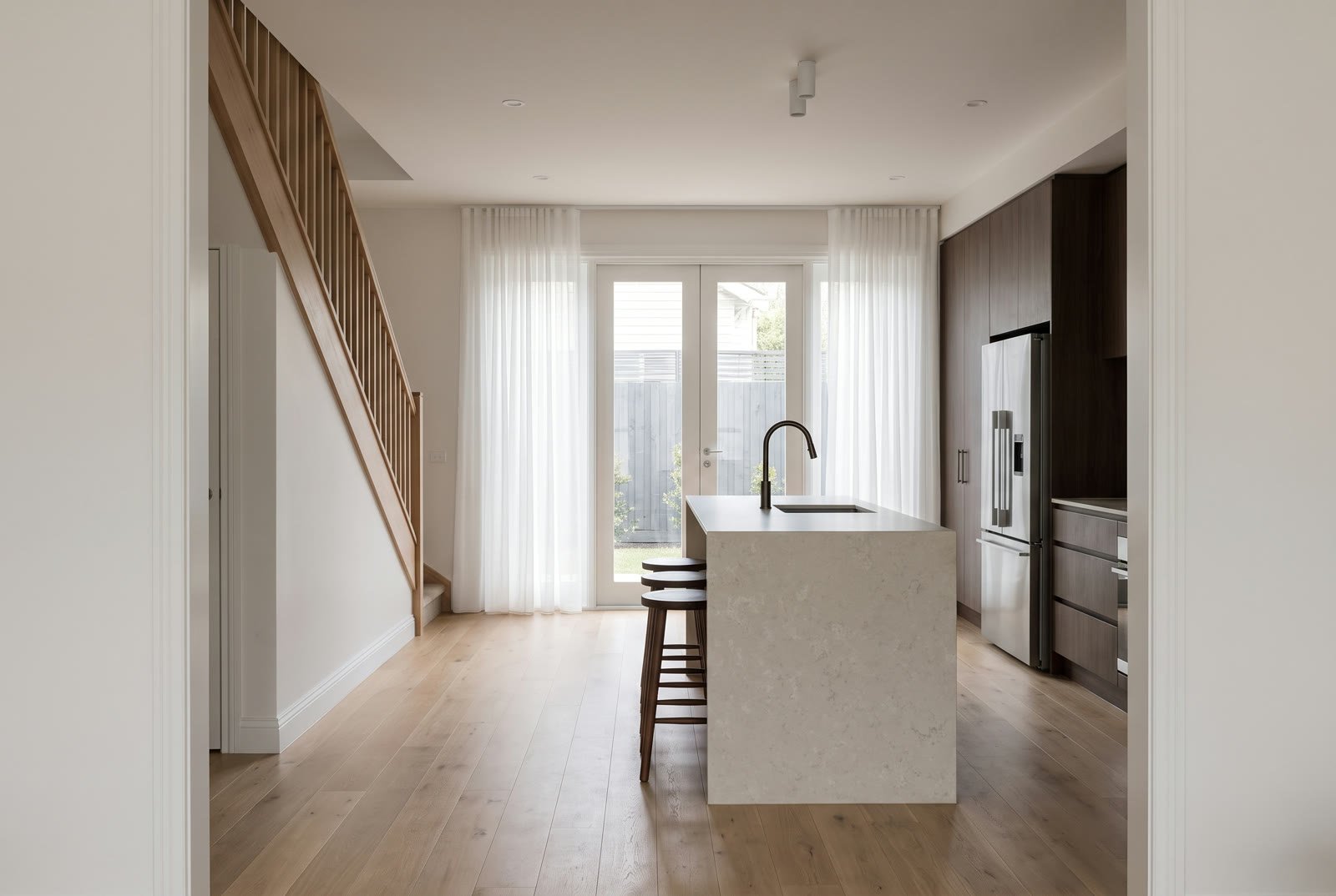 A kitchen and dining room in evening light